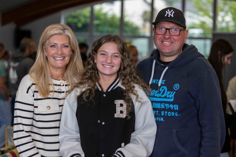 Taia celebrating her results with her parents
