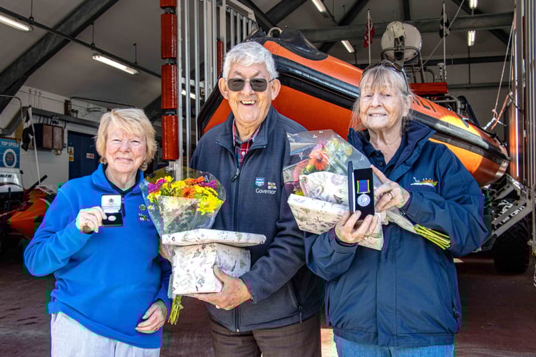 Looe RNLI's president John Trethewey presenting RNLI long service awards to Marilyn Berry (L) and Ann Watson (R)