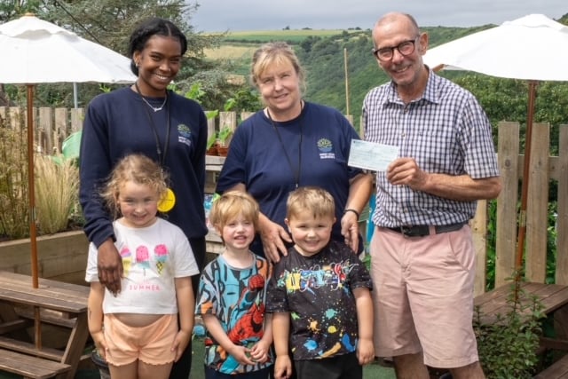 President of Looe Boat Owners Association Dave Peat presenting a cheque of £1000 to West Looe Nursery staff and toddlers.