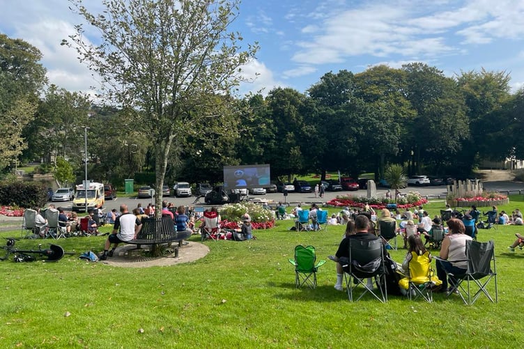 Crowds watch a film while basking in the sunshine at the Bodmin Town Council organised community cinema day