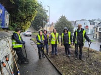Bodmin BlueTiTs brave the rain to transform overgrown part of town 