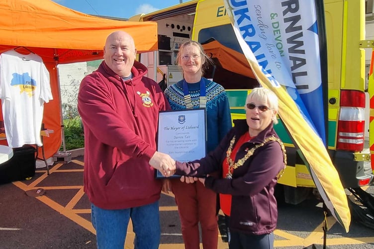 LIONS president Lisa Ince and Liskeard mayor Christina Whitty present Lion Darren Tait with a certificate of appreciation for his work to support people of Ukraine