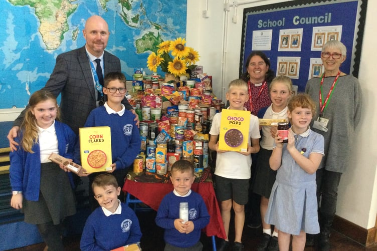 PUPILS of Brunel School in Saltash with headteacher Darren Woolner, Elizabeth of Saltash Foodbank and the Reverend Michelle Parkman