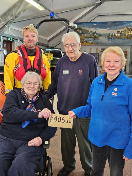Marilyn Berry accepting a donation from Barbara and David Jones with their grandson Goron Jones, a volunteer crew with the lifeboat. (Photo credit: RNLI Andrew Jones)