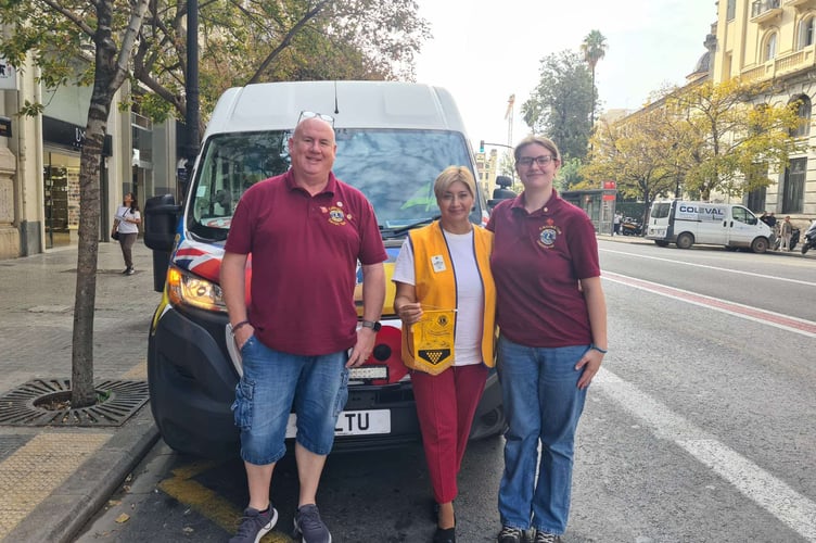The two-man team, here with a member of Lions Club of Valencia, delivered much needed equipment for the clean up operation, seen here outside the affected areas. (Picture: Darren Tait)