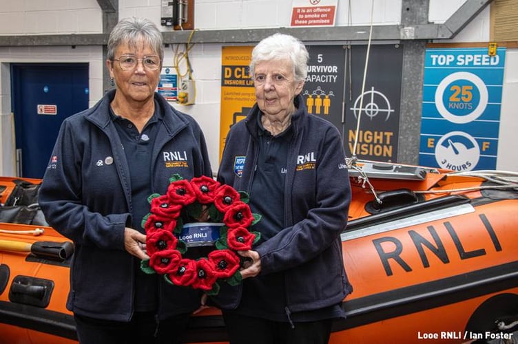 Looe RNLI volunteers Sue Bungey and Trish Calloway with the homemade wreath which travelled to London and will take pride of place at the Paddington war memorial. (Picture: RNLI/Ian Foster)