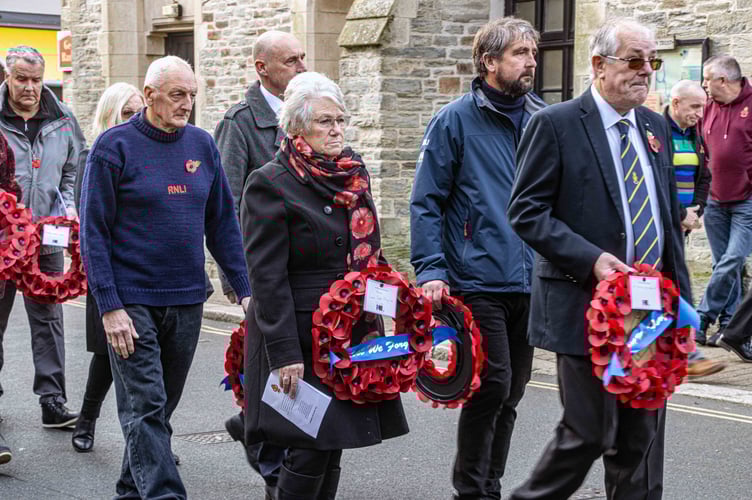 Looe RNLI's Dave Haines walking with others to the war memorial to lay wreaths on behalf of the community. (Picture: RNLI/Ian Foster)