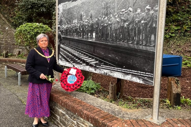 Mayor Cllr Julia Peggs laying a wreath at Saltash train station at a war memorial showing troops leaving for war. (Picture: STC) 
