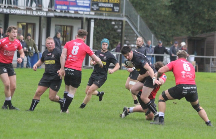 Launceston fly-half James Tucker looks to evade the attention of the Royal Wootton Bassett defence. Picture: Paul Hamlyn