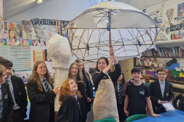 Student at Saltash Community School Kaye Nicholls holding the giant Mary Poppins umbrella lantern which is being created to her winning design. (Picture: Saltash Christmas Festival)