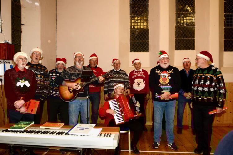 Halfway Harmony in full song together with accompanist Liz at the Kingsand and Cawsand light switch on. (Picture: Sue Clemens)