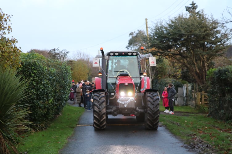 A festive tractor led the lantern parade at Downderry's Christmas event