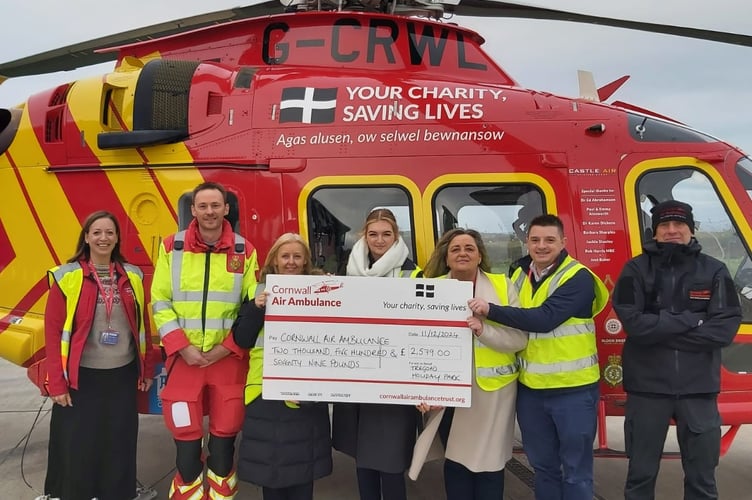 Staff from Tregoad Holiday Park hand over a cheque for £2,579 to representatives of the Cornwall Air Ambulance
