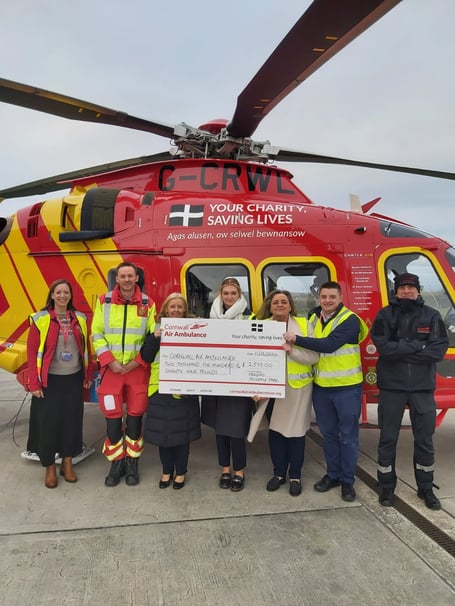 Staff from Tregoad Holiday Park hand over a cheque for £2,579 to representatives of the Cornwall Air Ambulance