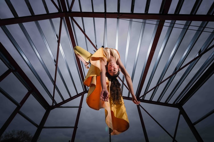 Ishita Raina of the Yskynna Vertical Dance Company performing from the steel frame of the building. Picture: Steve Tanner
