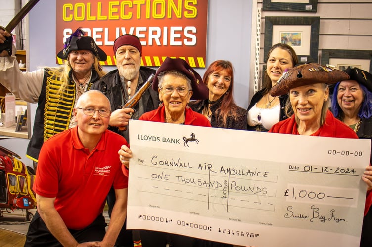 Members of the Pirates of St Piran present a cheque to the Cornwall Air Ambulance.