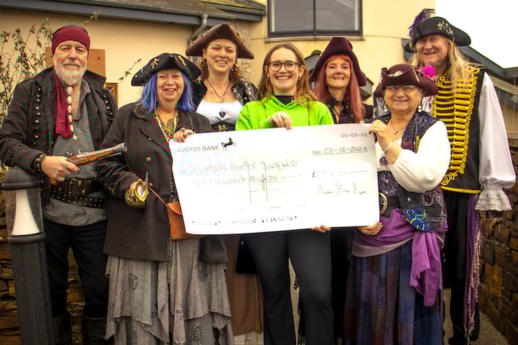 Members of the group giving a cheque to Children's Hospice South West.