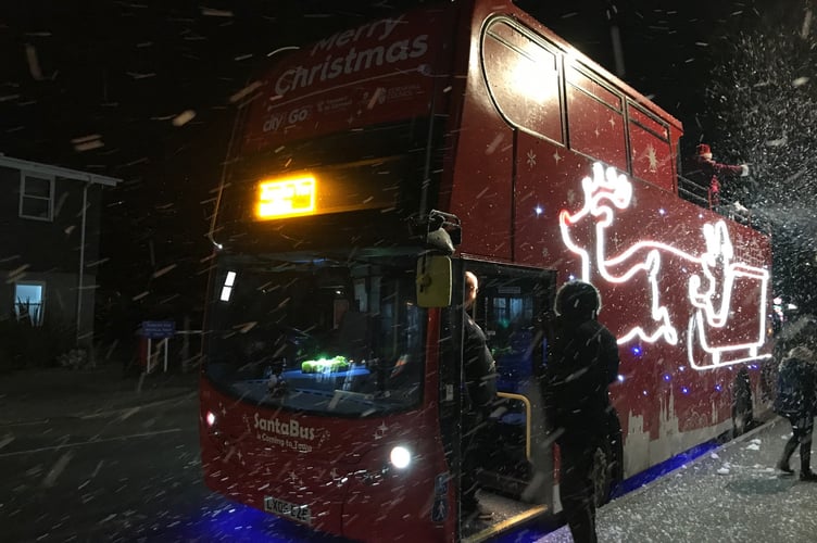 The SantaBus stopped off in Looe on the Torpoint-Looe leg of its tour of Cornwall bringing with it an unexpected snow storm. (Picture: Peter Murnaghan)