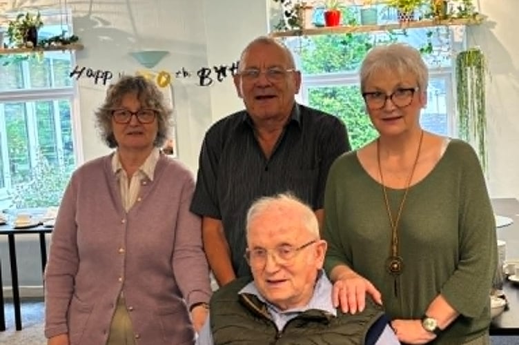 Saltash ex-butcher David Eggins celebrated his 100th Birthday surrounded by his children Peter, Liz and Judith enjoying a cake, and centenary card from King Charles. (Picture: Suzie Carroll)