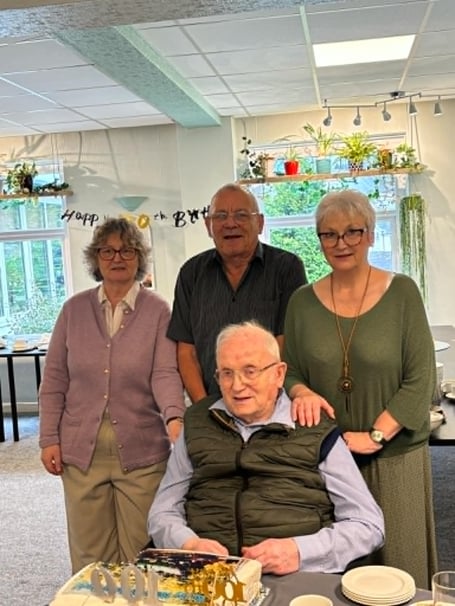 Saltash ex-butcher David Eggins celebrated his 100th Birthday surrounded by his children Peter, Liz and Judith enjoying a cake, and centenary card from King Charles. (Picture: Suzie Carroll)