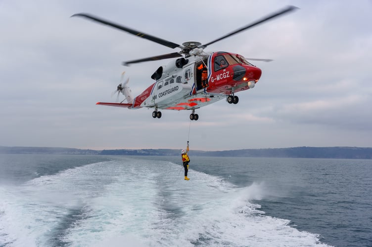 The Plymouth lifeboat rendezvoused with the Coastguard helicopter Rescue 924 leading to some dramatic photos of their helicopter rescue practise. (Picture: RNLI / Darren Blight) 