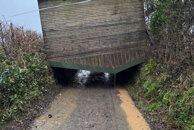 Storm winds lift horse shelter over hedge to block lane at Landulph
