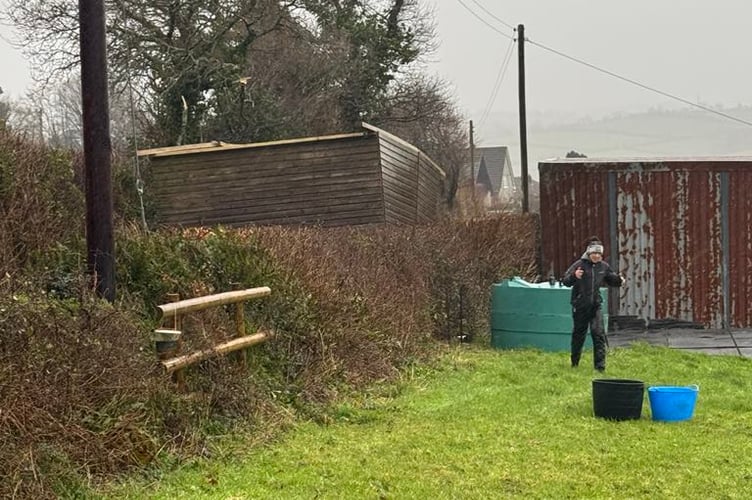 The field shelter weighed more than a tonne, and was flipped upside down as it was sent over the hedge by the wind landing in the lane behind. (Picture: Mike Bush)