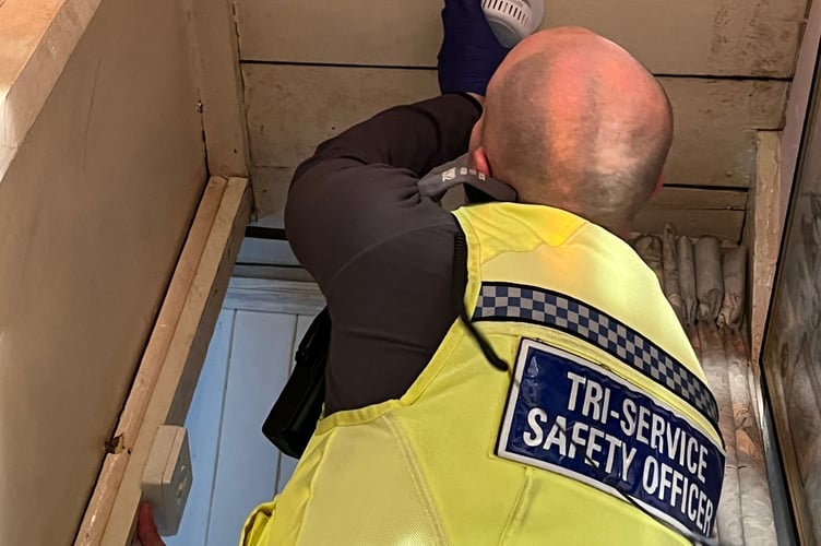TSSO Josh Harmon fits an extra smoke alarm