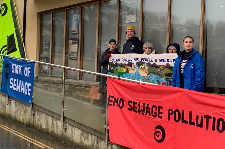 Protesters outside Looe's Millpool centre sending a clear message to South West Water at their Looe community roadshow event. (Picture: Sarah Martin)