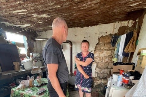ALINA with David Pond in 2023 in what remained of her home after a Russian strike laid waste to the settlement of Dovhenke