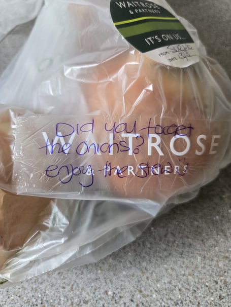 The message on Tom Coneybeare's shopping with two free onions "on" Waitrose after store partner Sue McCann realised they were missing in his order of classic stew ingredients. (Picture: Tom Coneybeare)