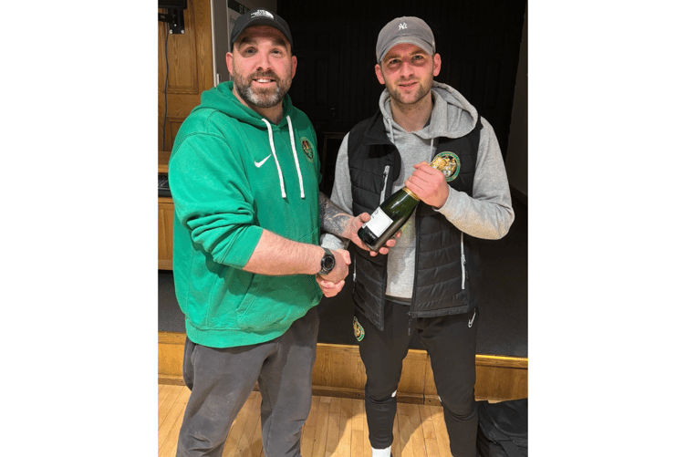 Tom Strike receives his man of the match award from manager Mark Carter. Picture courtesy of St Blazey FC.