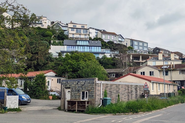 IN the foreground is the much needed and valued social housing site at Coombe Park in Downderry: behind on the hillside are houses more typical of the coastal parish