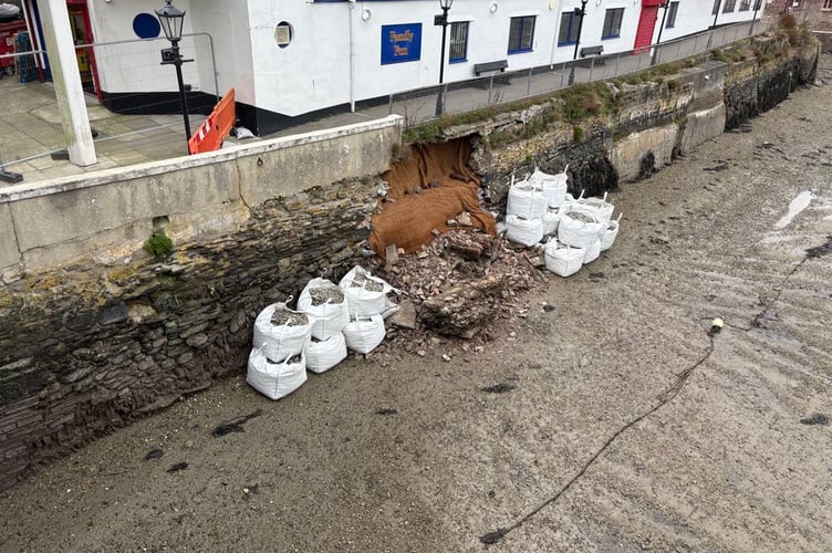 A first round of work has been undertaken to stabilise the hole in the harbour wall at West Looe. (Picture: Tracey Pickard)