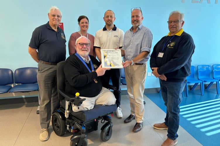 Members of the Torpoint & Rame Lions present the certificate of appreciation to the staff at the Rame Group Practice