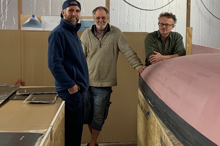 Angus Collins with Carbonish boatbuilders Ian Munslow and Carl Harwood back in November in the very early stages of the boat build in Millbrook. (Picture: Sarah Martin)