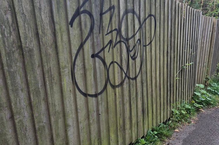 Another example of a fence with graffiti on it in Looe