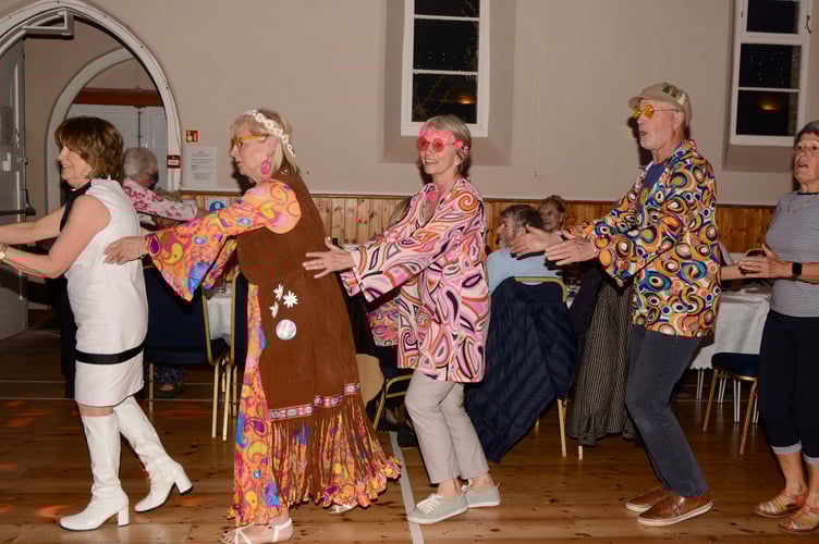 Revellers enjoying the 60s and 70s-themed evening at Maker in Rame Community Hall