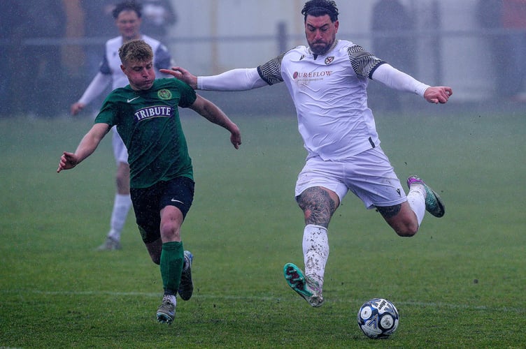 St Austell's Adam Carter looks to get a shot away during their Good Friday clash with St Blazey