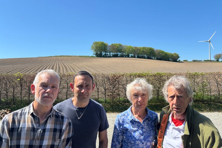 Pictured in front of just one of the fields mooted for a 105-acre solar farm at Lanreath are, from left, Gary Williams, Richard Kramer and Yolande and Bruce Milburn