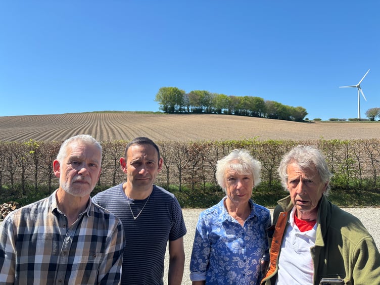 Pictured in front of just one of the fields mooted for a 105-acre solar farm at Lanreath are, from left, Gary Williams, Richard Kramer and Yolande and Bruce Milburn