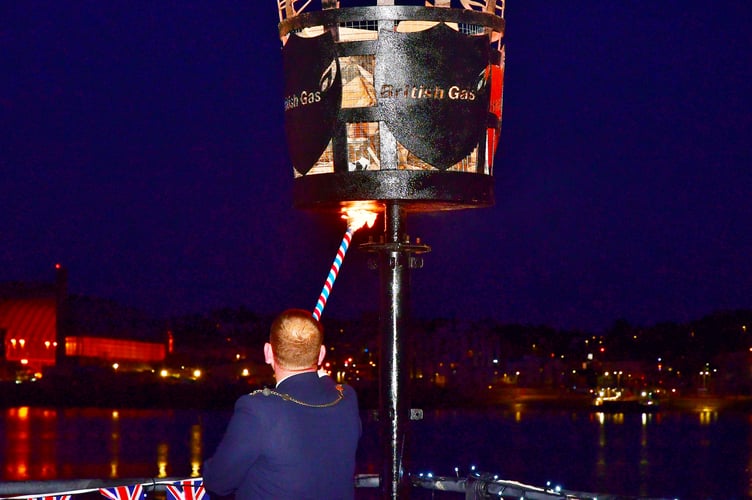 Torpoint Town Mayor, Cllr Gary Davis, lights the VE Day 80 celebrations beacon