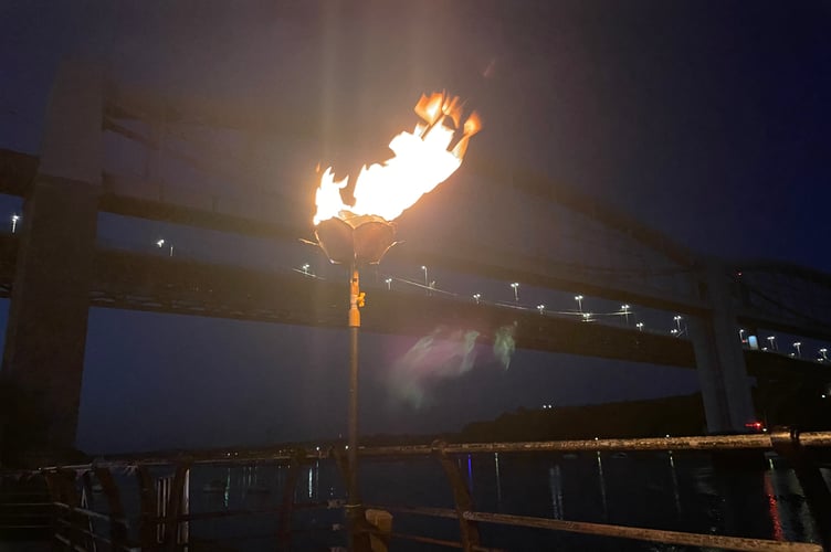 The VE Day 80 beacon lit down on Saltash's Waterside with the Royal Albert and Tamar Bridges in the background