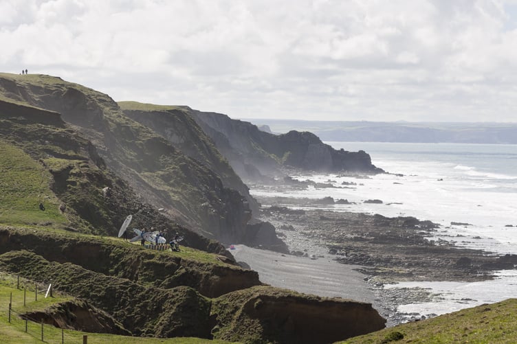 National Trust Surf Ambassadors on the cliff top above Sandymouth, Cornwall.