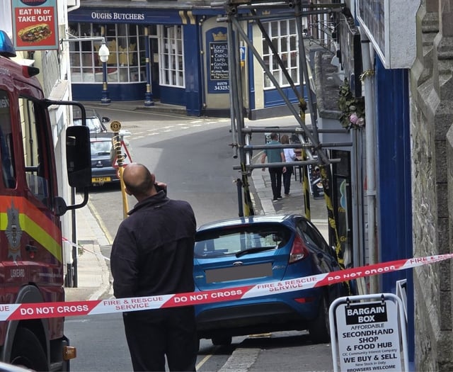 Town street shut after car collides into scaffolding