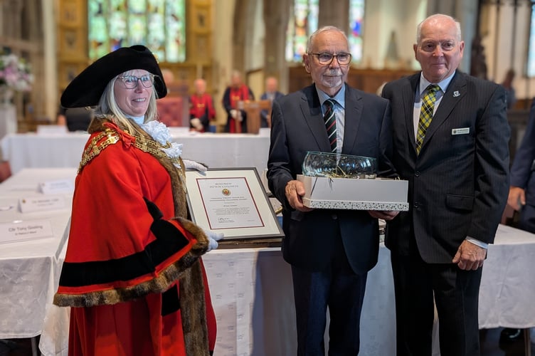 Cllr Liz Ahearn and Cllr Mike Barbery presenting an outstanding volunteer award to Brian Connor, who has retired after being the town's mace bearer for 38 years. (Picture: Aaron Greenaway/Tindle)