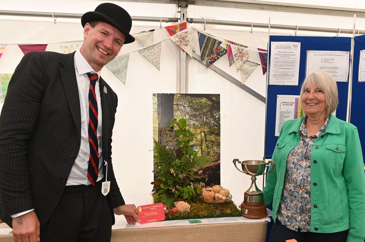 Royal Cornwall Show president Ed Coode was pleased to present the cup to the winning Women's Institute, Downderry and Seaton, represented by their president Ann Dollard. A lot of work had gone into their display, which carried the theme 'Fragile web of nature'.  Ann said: "It was a real group effort, there are many different elements. But it was really fun, we run a crafting group and it really started there."