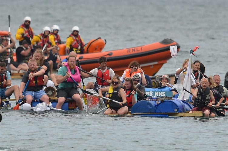 The Looe RNLI keep a watching brief as competitors take on the Looe Raft Race. Picture: (Jon Harris Photography)