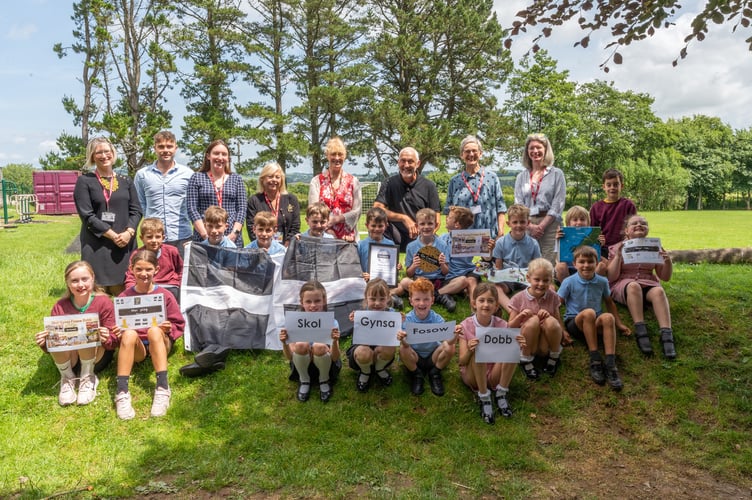 Youngsters from Dobwalls Primary School celebrate with local dignitaries after being awarded the Go Cornish Bronze award