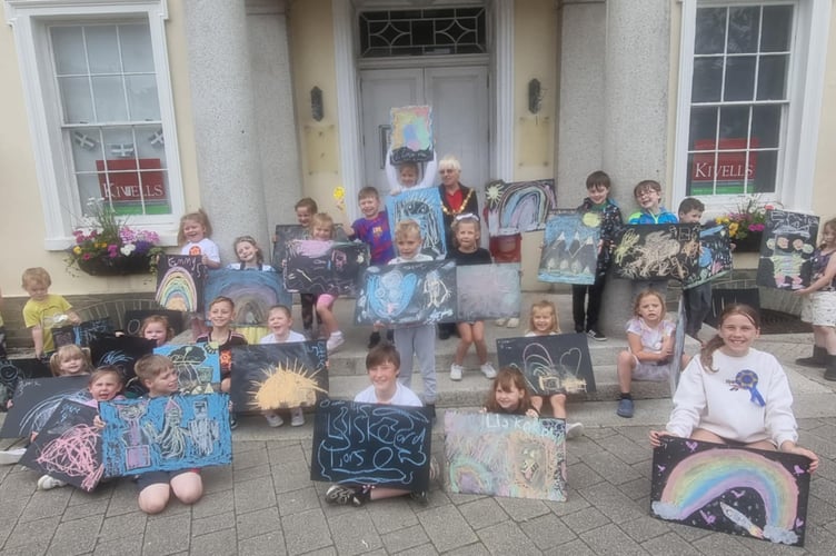 Youngsters proudly show off their pavement art in the recent competition run as part of Liskeard Lions Club Carnival events